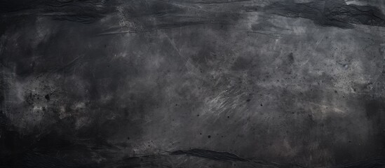 The blackboard is covered in chalk creating a monochrome pattern. The darkness contrasts with the soil and wood elements in the room