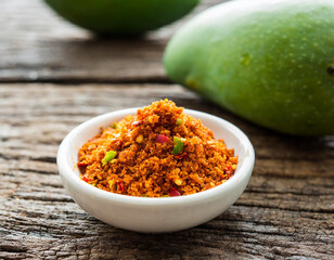 Fototapeta na wymiar Fresh green mango with table salt mixed with ground chili