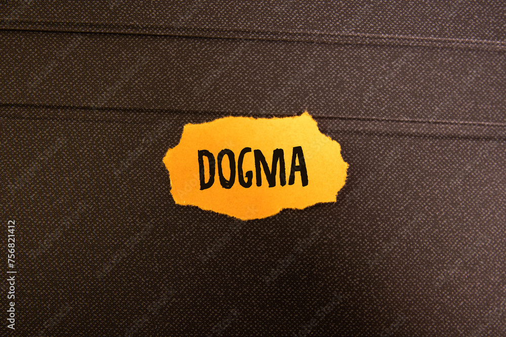 Poster dogma text on the wooden block with notebooks, keyboard with chart