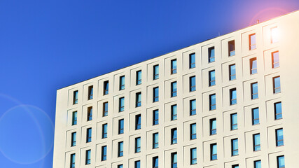 View of a white modern apartment building. Perfect symmetry with blue sky. Geometric architecture detail modern concrete structure building. Abstract concrete architecture. 