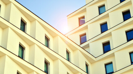 View of a white modern apartment building. Perfect symmetry with blue sky. Geometric architecture detail modern concrete structure building. Abstract concrete architecture. 