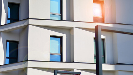 View of a white modern apartment building. Perfect symmetry with blue sky. Geometric architecture...