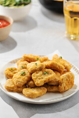Fast food chicken nuggets paired with a glass of apple juice