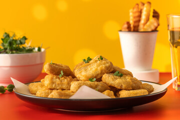 Plate of chicken nuggets and fries on table, food ready to eat