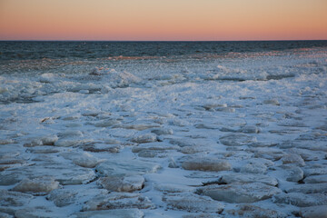 Frozen beach and water at sunset on Baltic sea, Saarema island, Estonia