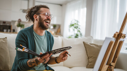 modern man with beard and mustaches paint painting at home hold brush