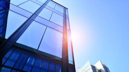 Modern office building with glass facade. Transparent glass wall of office building. Reflection of...