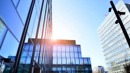 Modern office building with glass facade. Transparent glass wall of office building. Reflection of...