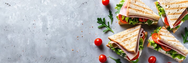 Tasty triangle sandwich with ham, cheese, tomato salad on neutral background, copy space included