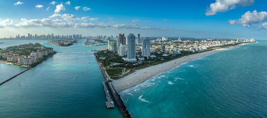 Aerial view of South Pointe Park in Miami with luxury condo towers, sandy beach, Government Cut waterway to carry cruise ship traffic