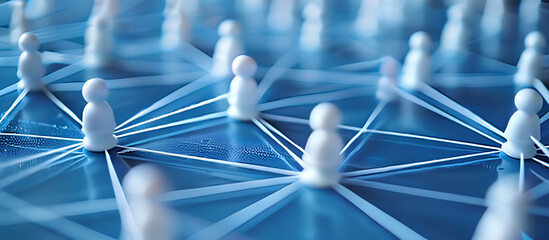 A group of small white figurines are positioned on a blue surface, symbolizing connected networking. The scene represents communication and marketing strategies in a simplistic visual form - obrazy, fototapety, plakaty