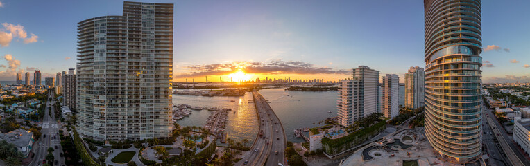 Sunset over causeway between two luxury apartment building on Miami Beach - obrazy, fototapety, plakaty