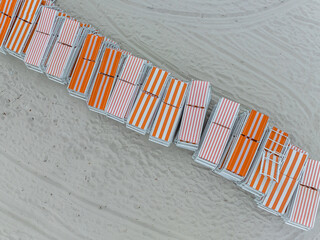 Orange white stripe beach chairs stacked on South Beach Miami