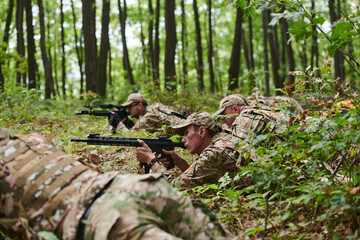 Elite soldiers stealthily maneuver through the dense forest, camouflaged in specialized gear, as they embark on a covert and strategic military mission