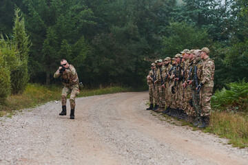 A major imparts precise military instructions to his elite unit, embodying strategic leadership as...