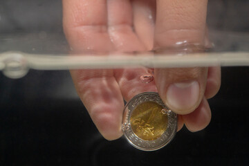 Egyptian Pound, Male Hand Holding Coin Under Water, Drowning Concept - obrazy, fototapety, plakaty