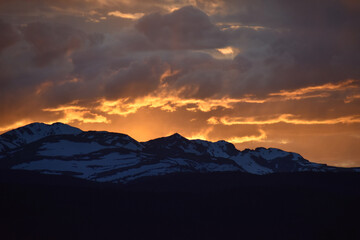 Sun Glowing Through the Clouds at Sunset Over the Rocky Mountains