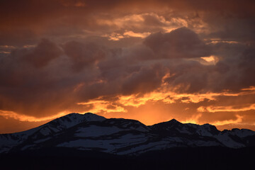 Sun Glowing Through the Clouds at Sunset Over the Rocky Mountains