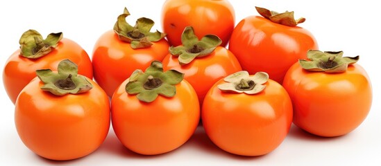 A bunch of persimmon fruits, a type of plum tomato, displayed on a white background. Persimmons are...