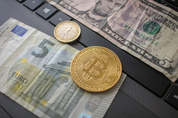 bitcoin and euro with five euro and five dollar bank notes