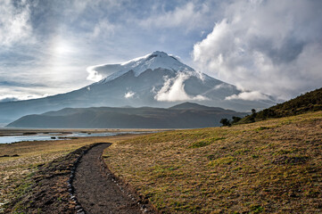 Path to the Limpiopungo lagoon and the Cotopaxi volcano on a bright cloudy day