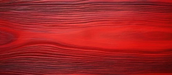 Fotobehang A detailed close up of a red wood grain texture, with shades of amber, orange, magenta, and peach creating a beautiful pattern resembling a red sky at morning © 2rogan