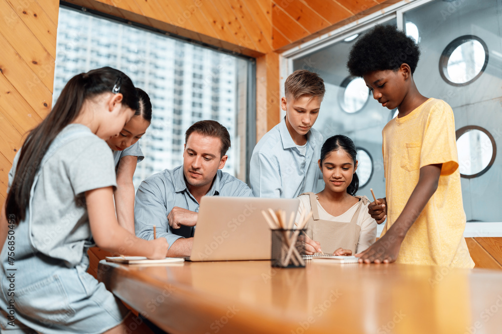 Poster during a lecture course teacher sitting and use laptop. students standing and separate to two group 
