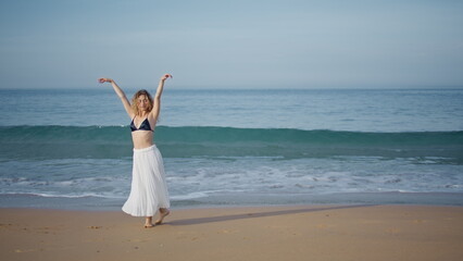 Fototapeta na wymiar Romantic girl performing dance on beautiful sand beach. Choreographer dancing 