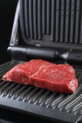 Cooking fresh beef cut on electric grill