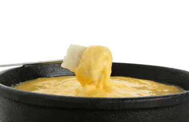 Dipping piece of bread into fondue pot with tasty melted cheese isolated on white