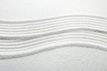 Fototapeta na wymiar Zen rock garden. Wave pattern on white sand