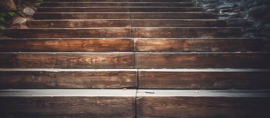 A closeup of a set of wooden stairs with a metal railing, complimented by the warm tones of brown wood, brickwork, and a nearby window - obrazy, fototapety, plakaty