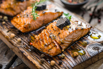 Salmon fillets with seasoning on wood.
