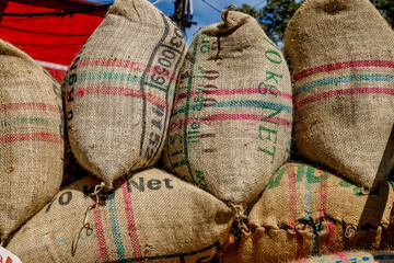 Burlap bags with Colombian coffee beans stacked in a truck