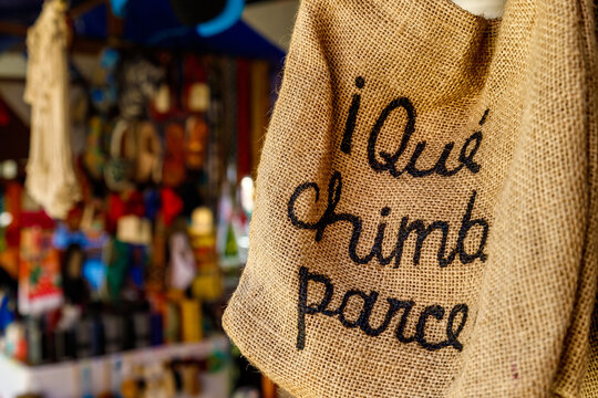 Burlap bag with the inscription in Spanish "Wonderful, friend!" hanging in a market