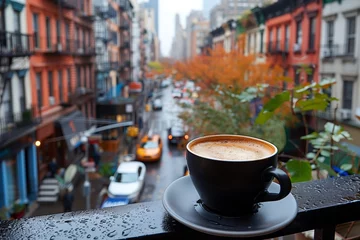 Photo sur Plexiglas TAXI de new york Coffee Cup Overlooking Rainy New York Street. Steaming coffee cup sits on a balcony railing, overlooking a rainy New York street bustling with taxis.