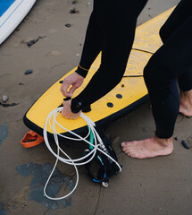Surfer adjusting leg straps