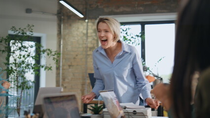 Overjoyed boss celebrating achievement team with office colleagues close up.