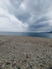 Photo of Street in Lampa Strait area, Natuna Island. The road is on a rock wall and borders the South China Sea. A scenic road leads to the harbor.
