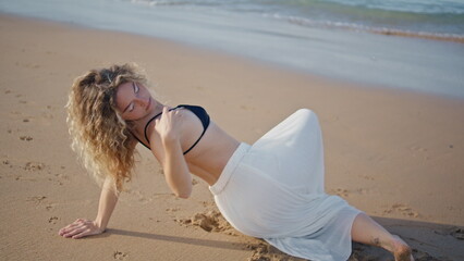 Girl performing dance sand sunny beach close up. Sensual woman moving smoothly 