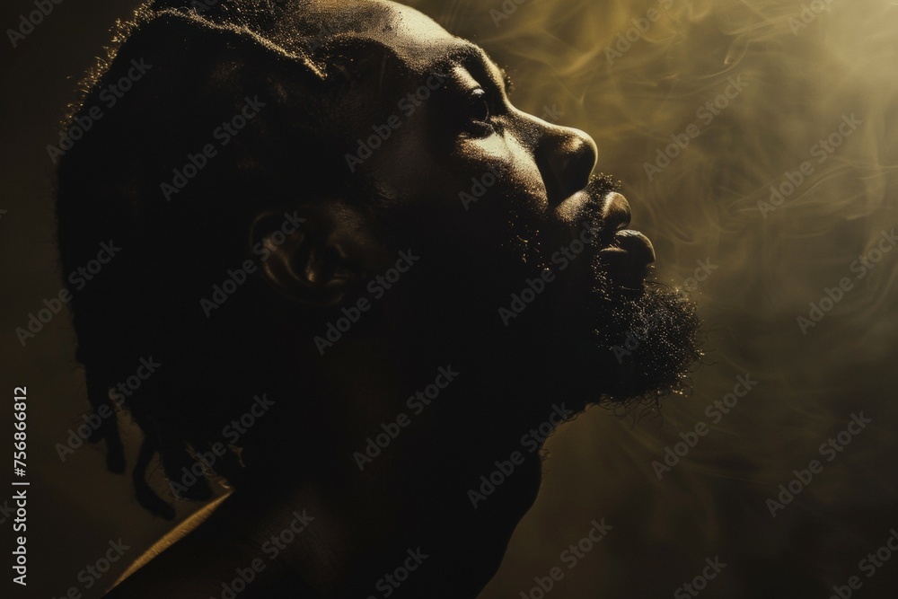 Poster a man with a beard and dreadlocks is looking up at the camera