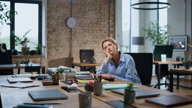 Woman employee bored office coworking alone closeup. Weary businesswoman work