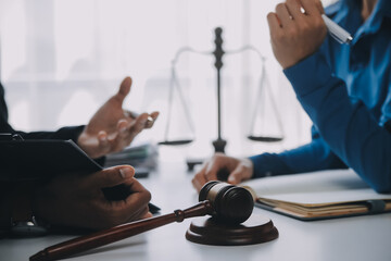 Justice and Law concept. Legal counsel presents to the client a signed contract with gavel and...