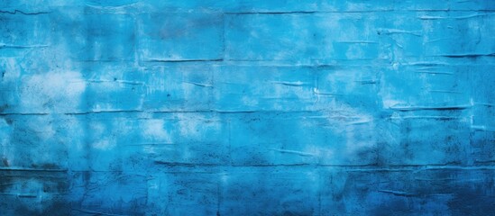 Fototapeta na wymiar A close up of a symmetrical pattern of aqua and electric blue rectangular bricks, showcasing tints and shades of blue with a mesmerizing fontlike design