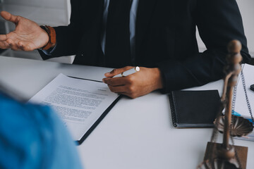 Justice and Law concept. Legal counsel presents to the client a signed contract with gavel and...