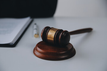 Justice and Law concept. Legal counsel presents to the client a signed contract with gavel and...