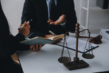 Justice and Law concept. Legal counsel presents to the client a signed contract with gavel and...
