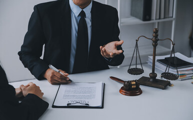 Justice and Law concept. Legal counsel presents to the client a signed contract with gavel and...