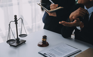 Justice and Law concept. Legal counsel presents to the client a signed contract with gavel and...