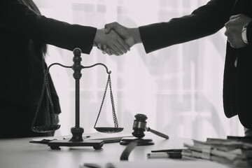 Justice and Law concept. Legal counsel presents to the client a signed contract with gavel and...